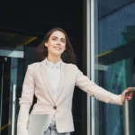 A worker leaving an office early while a CEO watches the time