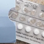 A person holds a birth control pill pack while researchers debate changing attitudes toward contraception