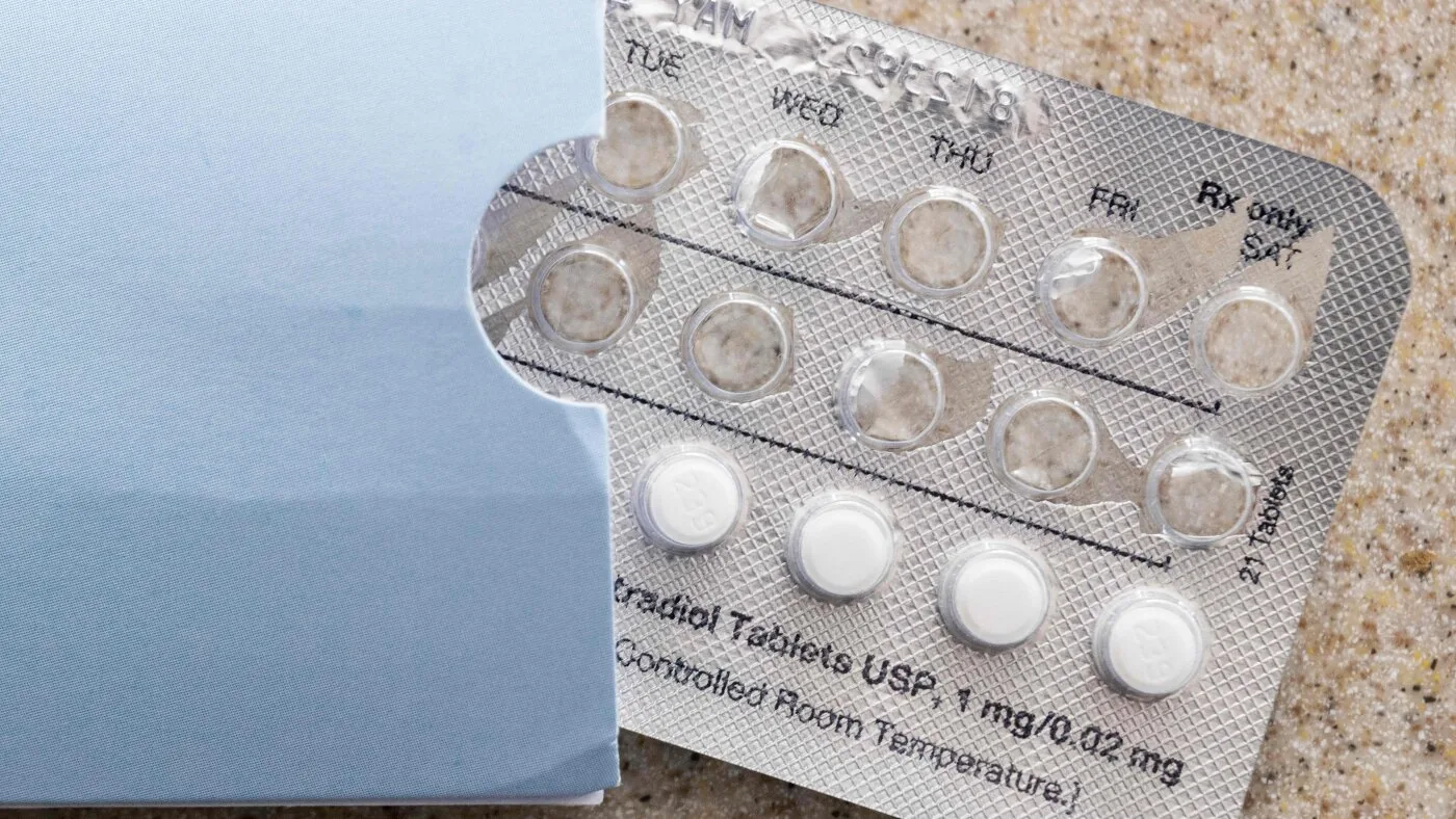 A person holds a birth control pill pack while researchers debate changing attitudes toward contraception