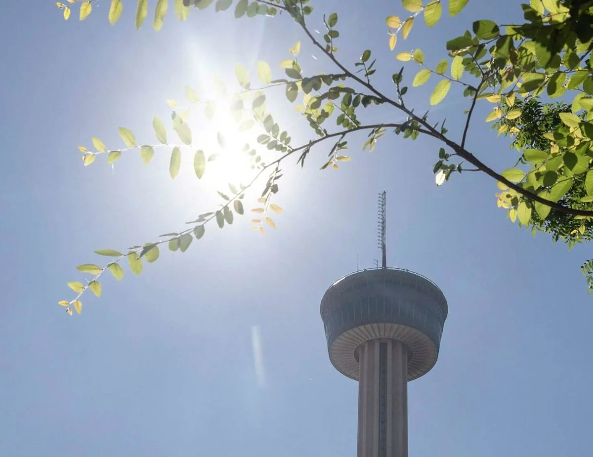 Downtown San Antonio skyline under bright summer heat and scattered clouds